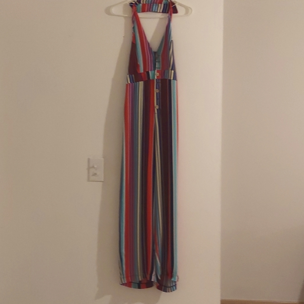 Jumpsuit multicolor, open back. Fits more like a small.